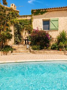 a house with a swimming pool in front of a house at La Villa des Restanques in Carry-le-Rouet