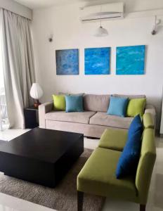 a living room with a couch and a coffee table at apartmentleeza in Uswetakeiyawa +1 photo