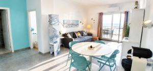 a living room with a table and a couch at Like-Home-T1-Sun & Beach-Pools, AC in Ericeira