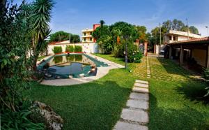 a backyard with a swimming pool and grass at Il Veliero E I Girasoli in Taureana