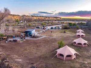 a group of tents in a field with a parking lot at Mesa Verde Tent in Farmington