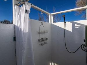a bathroom with a shower with a shower curtain at Mesa Verde Tent in Farmington