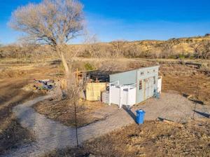 a building in the middle of a field at Mesa Verde Tent in Farmington