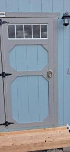 a sliding glass door on a blue building at Mesa Verde Tent in Farmington +8 photos