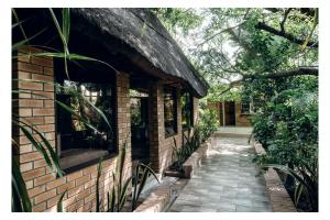 a brick building with a walkway next to a building at Leon's Lodge in Choma
