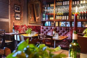 a bar with couches and tables in a restaurant at The Roebuck Inn in Mobberley