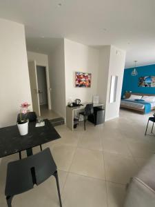 a living room with a table and chairs and a bed at Maqueda Suites in Palermo