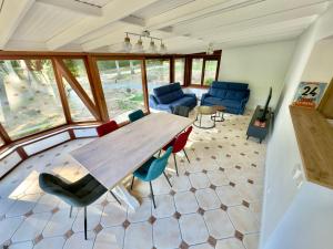 a large room with a wooden table and chairs at Gîte Chez Armande in Surfonds +10 photos
