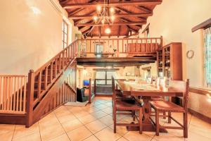 a dining room with a table and a staircase at Fyllosia Villa Part of Cretan Retreat in Archanes