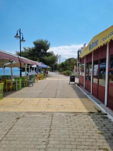 a street with tables and chairs and a building at Calma4 in Agioi Theodoroi +3 photos