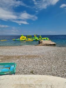 a playground on a beach next to the water at Calma4 in Agioi Theodoroi