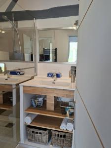 a bathroom with two sinks and two mirrors at Gîte, Le Séchoir à Lin demeure de charme in Veauville-les-Baons