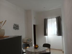 a dining room with a table and a window at Oasi nel cuore di Noto in Noto