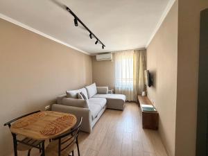 a living room with a couch and a table at Apart Mi in Novi Sad