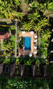 an aerial view of a resort with a swimming pool and palm trees at Mahaloka Valley Nusa Penida in Nusa Penida