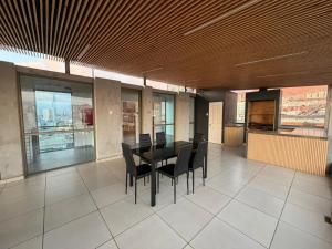 a dining room with a black table and black chairs at Hoteles JMC in Antofagasta