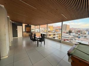 a dining room with a view of a city at Hoteles JMC in Antofagasta