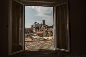 an open window with a view of a city at A Cà Da Nonna Di Callo Luca in Vernazza