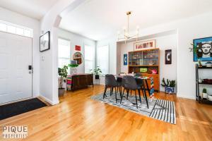 a living room with a table and chairs at The Obsolete Suite - HotTub - King Bed - AC - Pet Friendly in Edmonton