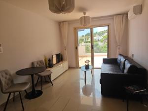 a living room with a couch and a table at Sun Set at Coral Bay in Peyia