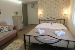 a bedroom with a bed with two pillows on it at Efterpi seaside house in Chrysi Ammoudia +42 photos