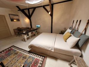 a bedroom with a large bed and a table at Kranich in Ueckermünde