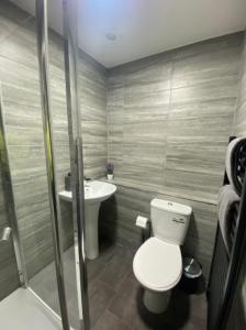 a bathroom with a toilet and a sink at Roomello luxury City Studios in Peterborough +30 photos