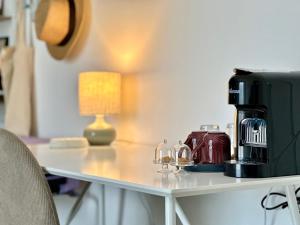 a coffee maker sitting on a table with a lamp at Maison Pompei in Pompei