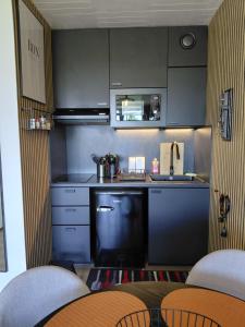 a small kitchen with a sink and a counter top at Le 408 des pistes in La Bresse