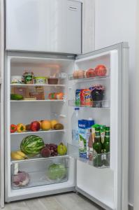 an open refrigerator filled with food and fruits and vegetables at My Villa Naxos in Naxos Chora