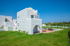a white villa with a yard and a swimming pool at My Villa Naxos in Naxos Chora
