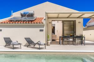 a villa with a swimming pool and a house at La Villa Du Soleil in Sami