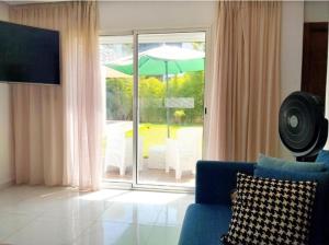 a living room with a blue couch and an umbrella at Luxury big House in hearth of Hay Riad with big garden in Rabat