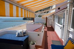 a balcony of a house with a view of the beach at Beachfront Apartment - 2 Terraces - Stunning Sunrises in Gibraltar