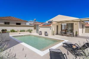 a swimming pool in the backyard of a house at La Villa Du Soleil in Sami +18 photos