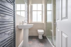 a bathroom with a sink and a toilet at Cameron Fell Apartment Keswick at The Lairbeck in Keswick +18 photos