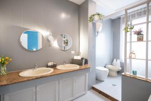 a bathroom with two sinks and a toilet and mirrors at Maison Pompei in Pompei +184 photos