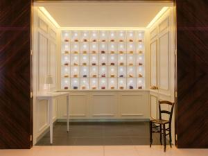 a room with a cupboard filled with lots of vases at St Martins Lane London in London