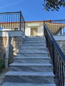 a set of stairs leading up to a house at Olive Hill in Ancient Epidauros