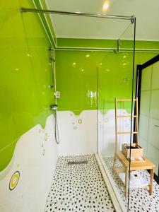 a bathroom with a shower with a green wall at Ami Residence Bucharest Airport,Therme&FREE PARKING Otopeni in Otopeni +31 photos