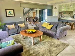 a living room with couches and a coffee table at Greens & Dreams in Parys