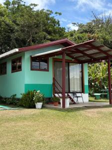 a green house with a red roof at Campo Azul #2 - Monteverde in Monteverde Costa Rica