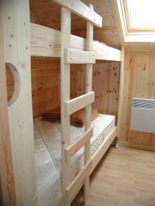 a wooden cabin with a bunk bed in a room at Les Rochettes - Jupiter in La-Roche-en-Ardenne