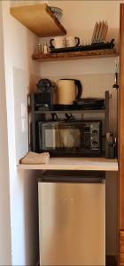a kitchen with a stove and a microwave at Pefkos Sea Shell in Pefki