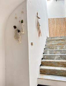a stairway with some decorations on the wall at Il Cortiletto in Rocca Cilento +39 photos