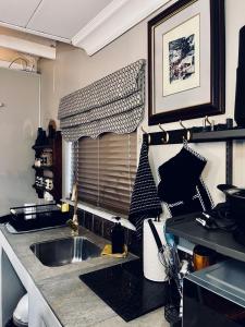 a kitchen with a sink and a window at Highveld Guesthouse in Centurion +53 photos