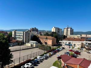 a parking lot with cars parked in a city at Apartman Stankovic in Pirot
