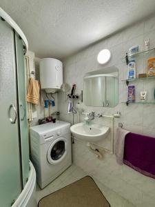 a bathroom with a washing machine and a sink at Apartman Stankovic in Pirot