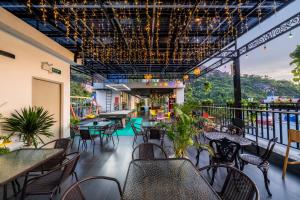 a restaurant with tables and chairs on a balcony at Catba Vista Hotel - New 2026 - Infinity Pool in Cat Ba