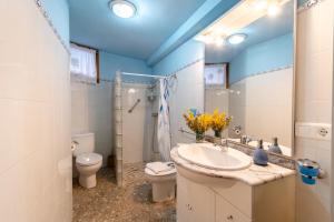 a bathroom with a sink and a toilet at CASA LA FELICIDAD in Beceite +18 photos